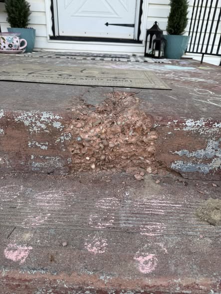 Concrete step with large spalled section blown out in Aliquippa before repair