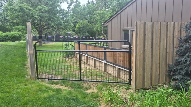 Old metal fence gate before replacement in Moon Township