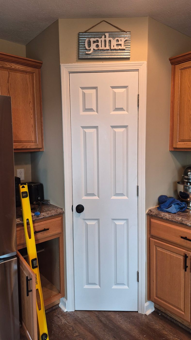 Newly installed white six-panel interior door in a Coraopolis kitchen