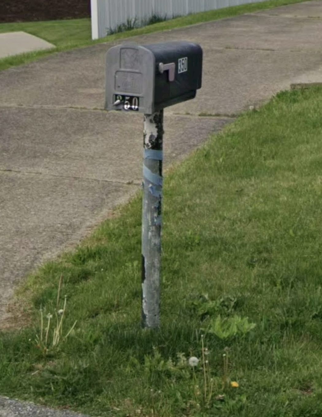 Rotted, peeling mailbox post held together with tape in Robinson Township before replacement