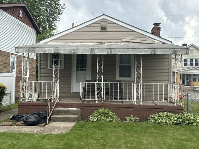Old rusting ornamental porch railings before replacement in Neville Island